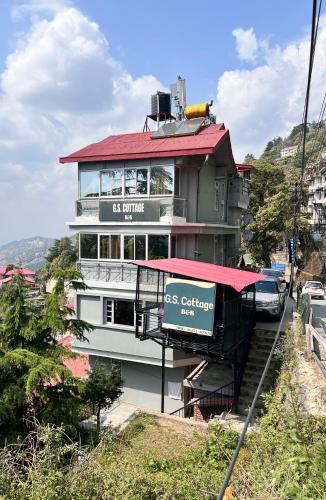 a large building with a sign on the side of it at GS cottage Bed and Breakfast walking distance from Mall Road in Shimla