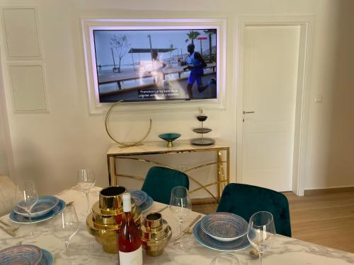 a dining room table with a television on the wall at Luxury Villa Olga in Biograd na Moru