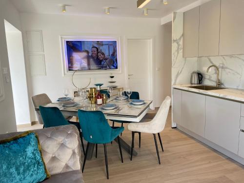 a kitchen and dining room with a table and chairs at Luxury Villa Olga in Biograd na Moru