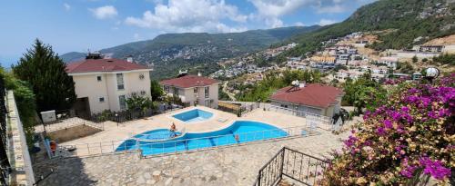 a house with a swimming pool in front of a mountain at Ambiance Delux Villa with a Private Pool and a View in Alanya