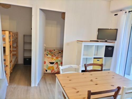 Cette petite chambre comprend une table et une télévision. dans l'établissement jardin plein sud, vue montagne, proche Luz Saint Sauveur, à Luz-Saint-Sauveur