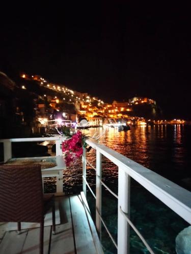 a balcony with a view of the water at night at Al Quindici Scilla in Scilla