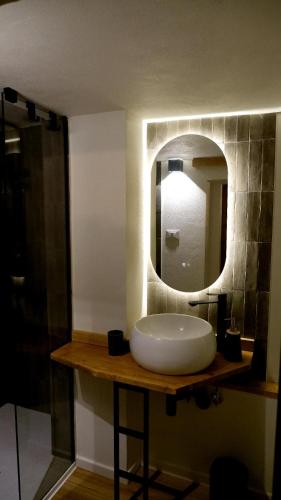 a bathroom with a white sink and a mirror at Agada Suite in Aci Castello