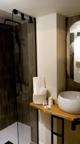 a bathroom with a sink and a shower at Agada Suite in Aci Castello