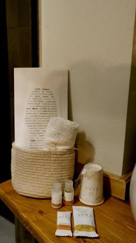 a basket of towels sitting on a wooden table at Agada Suite in Aci Castello
