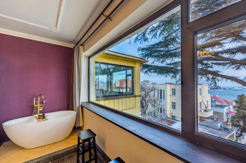 a bathroom with a tub and a large window at September Republic of China Residence in Qingdao in Qingdao