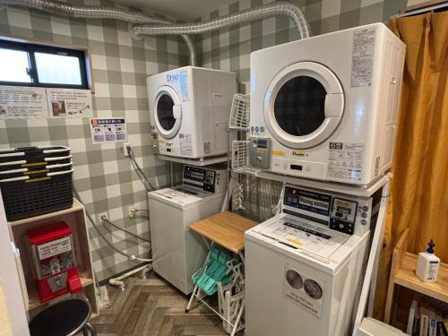 a laundry room with several washing machines and appliances at GuestHouse Guu in Fujikawaguchiko