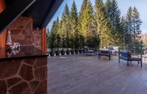 a patio with chairs and tables and trees at Cozy Home In Ravna Gora With Sauna in Ravna Gora