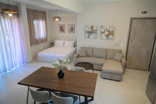 a living room with a bed and a table at Sotale Suites in Apolpaina
