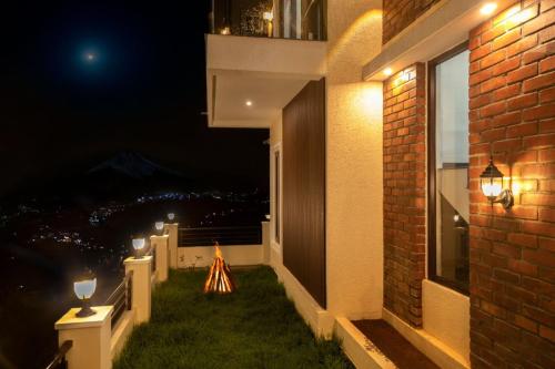 a balcony with a view of the city at night at May Flower Cottage in Ooty