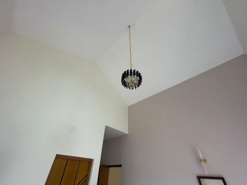 a room with a chandelier hanging from a ceiling at May Flower Cottage in Ooty