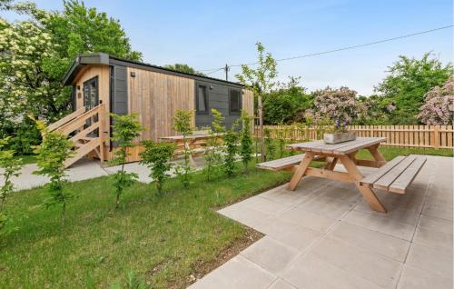 a picnic table in a backyard with a tiny house at Gorgeous Home In Erkheim With Wifi in Erkheim