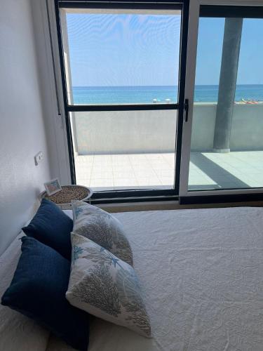 a bedroom with a bed with a view of the ocean at Duplex de Zoraida in Roquetas de Mar