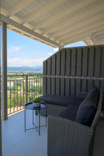 a living room with a couch and a table on a balcony at Sotale Suites in Apolpaina