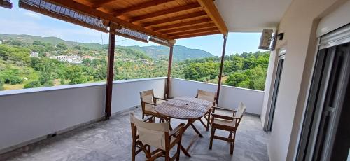 a balcony with a table and chairs and a view at Villa Kavourakia in Kolios