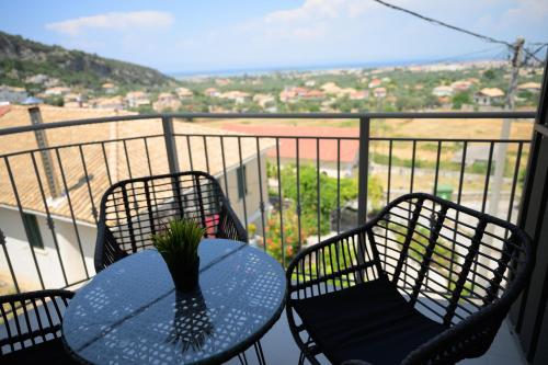 a table and chairs on a balcony with a view at Sotale Suites in Apolpaina