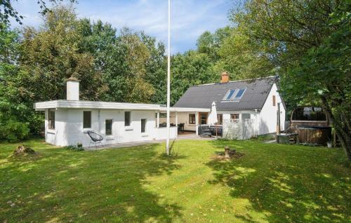 a white house with a yard in front of it at Lovely Home In Thyholm With Sauna in Thyholm