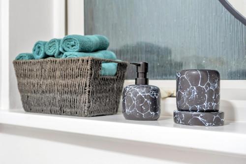a bathroom counter with towels and a basket of towels at Contractors Welcome to Chantry close stay! in Peterborough