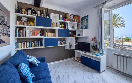 a living room with a blue couch and book shelves at Nice Apartment In Sestri Levante in Sestri Levante