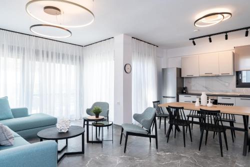 a kitchen and living room with a table and chairs at Olympiada Residential Complex & Villas in Ofrínion