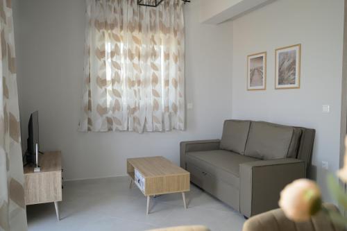 a living room with a couch and a table at Sotale Suites in Apolpaina