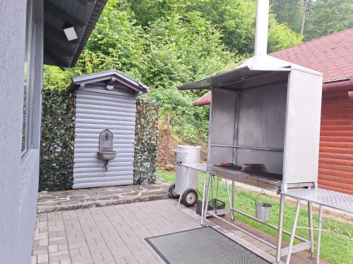 a barbecue grill sitting outside of a house at Case de vacanță Gabriel in Sovata