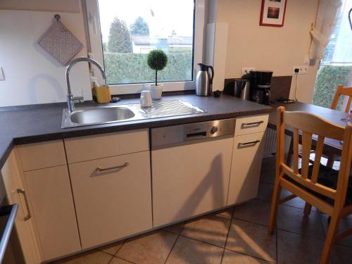 a kitchen counter with a sink and a window at Ferienhaus Geers am Klostersee Dargun in Dargun