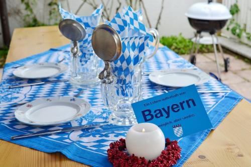 a table with a candle on a blue and white table cloth at BayernBlick in Rimsting