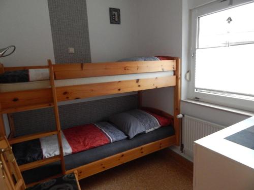 two bunk beds in a room with a window at Ferienhaus Geers am Klostersee Dargun in Dargun
