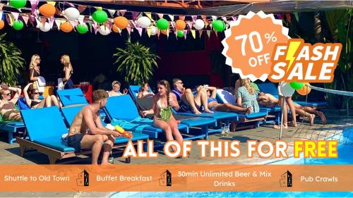 a group of people sitting on beach chairs at a pool at Bed Station Hostel & Pool Bar Hội An " Former Sunflower" in Hoi An