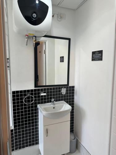 a bathroom with a sink and a mirror at Queen Julie Lodge in Cape Town