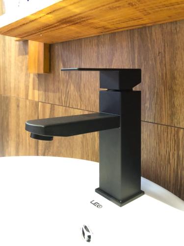 a modern black kitchen faucet on a wall at Tunnel Top Inn Ella in Ella