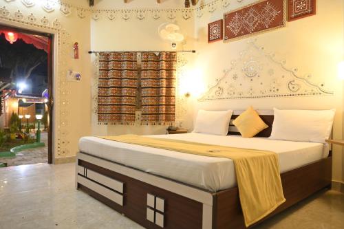 a bedroom with a large bed in a room at Shyam Homestay in Bhuj