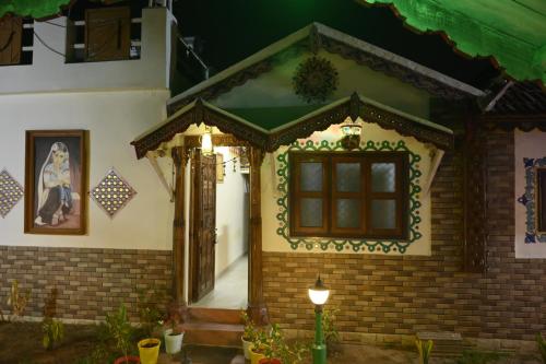 a small house with a window and a light at Shyam Homestay in Bhuj