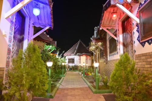a street with houses lit up at night at Shyam Homestay in Bhuj