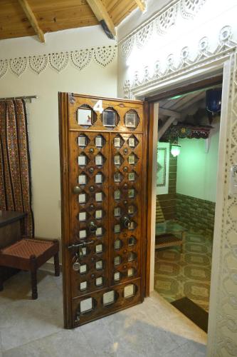 a wooden wine cellar with a bunch of wine bottles at Shyam Homestay in Bhuj
