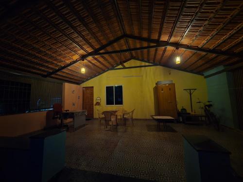 a large room with a table and chairs in it at Nisarga nivas in Mysore