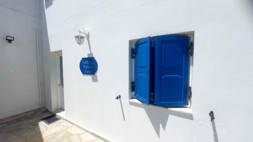 a blue window on the side of a white wall at Kalliopi's Aegean View in Episkopíon