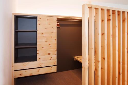 a closet with wood paneling and a window at Hotel Cristal in Obereggen
