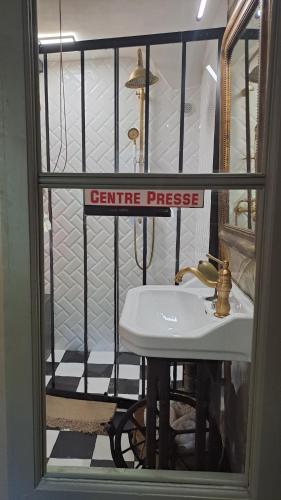 a bathroom with a white sink in a window at La Maison du Griffoul BB à Salles la Source cascade et terroir in Salles-la-Source
