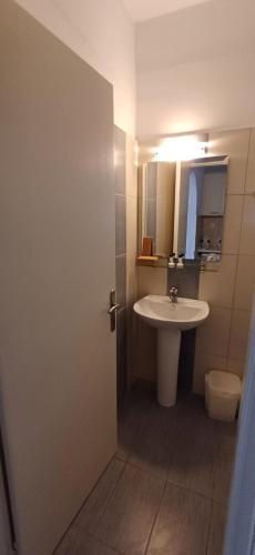 a bathroom with a sink and a toilet and a mirror at Villa Kavourakia in Kolios