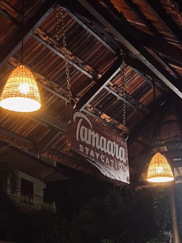 a sign hanging from the ceiling of a restaurant at Tamaara Staycation in Varkala