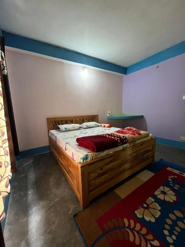 a bedroom with a wooden bed in a room at Brindavan Homestay in Mirik