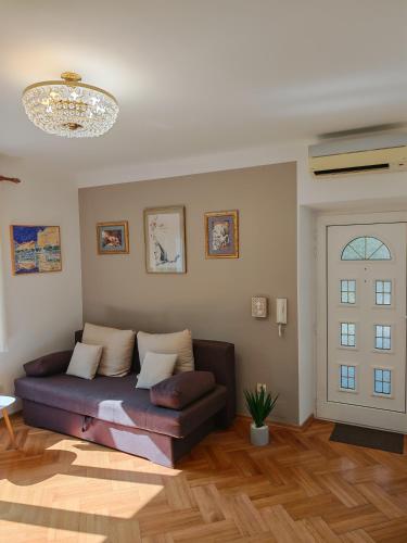 a living room with a couch in a room at Vallelosca Garden in Opatija