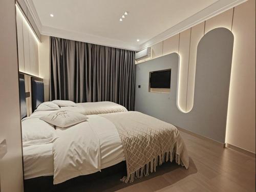 Postel nebo postele na pokoji v ubytování Longchen Hotel
