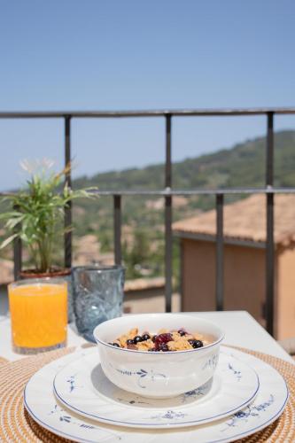 a bowl of food on a plate on a table at Petit Biniaraix in Sóller