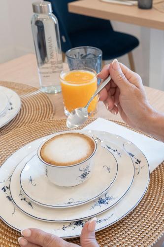 a person eating a cup of coffee on a table at Petit Biniaraix in Sóller