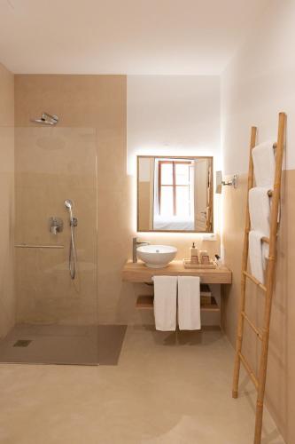 a bathroom with a sink and a shower at Petit Biniaraix in Sóller