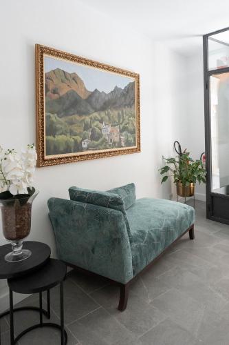 a living room with a couch and a picture on the wall at Petit Biniaraix in Sóller