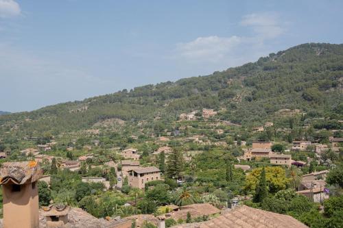 a village on a hill with houses and trees at Petit Biniaraix in Sóller